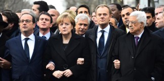From left: French President Francois Hollande, German Chancellor Angela Merkel, President of the European Council Donald Tusk, Palestinian Authority President Mahmoud Abbas link arms during a silent march against terrorism in Paris on Jan. 11, 2015 following the attack on French satirical weekly Charlie Hebdo and a kosher supermarket.